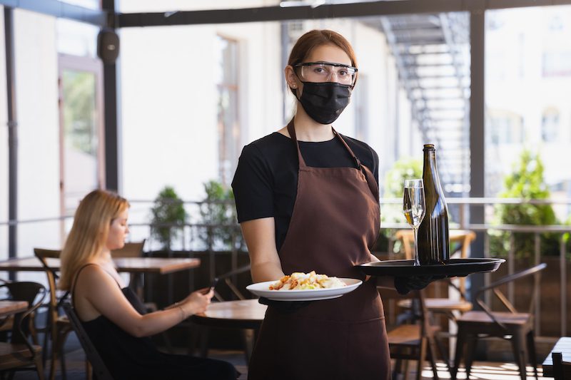 waitress works restaurant medical mask gloves during coronavirus pandemic - Lionheart safety